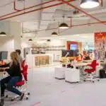 woman in red long sleeve shirt sitting on black rolling chair