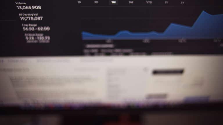 Financial data dashboard showing trading volume and price range fluctuations, photo by Markus Spiske on Unsplash.